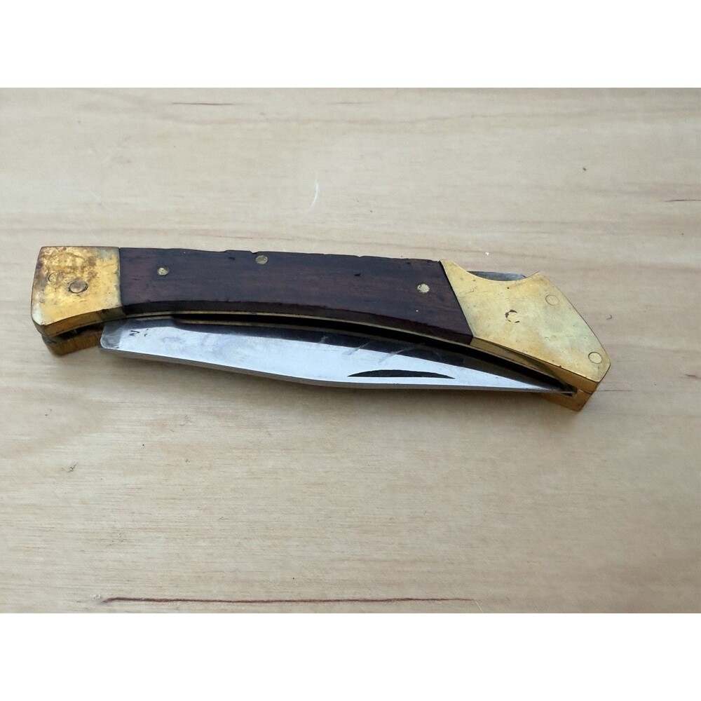 Vintage folding lockback knife with wood handle and brass bolsters